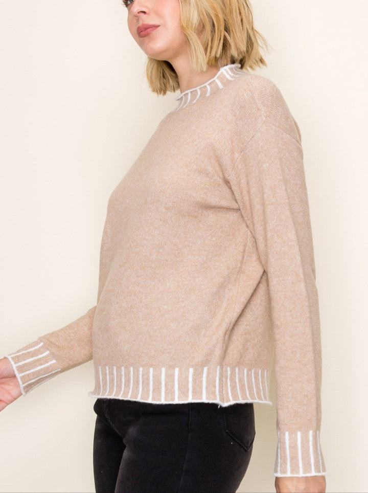 Stay cozy and stylish in the Kerr Mock Neck Sweater, featuring a charming color texture accent that adds a fun twist to your everyday look. Its playful mock neck design keeps you snug while letting your personality shine. Perfect for layering or wearing solo, this sweater brings warmth and a pop of character to chilly days.
