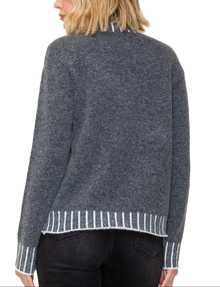 Stay cozy and stylish in the Kerr Mock Neck Sweater, featuring a charming color texture accent that adds a fun twist to your everyday look. Its playful mock neck design keeps you snug while letting your personality shine. Perfect for layering or wearing solo, this sweater brings warmth and a pop of character to chilly days.