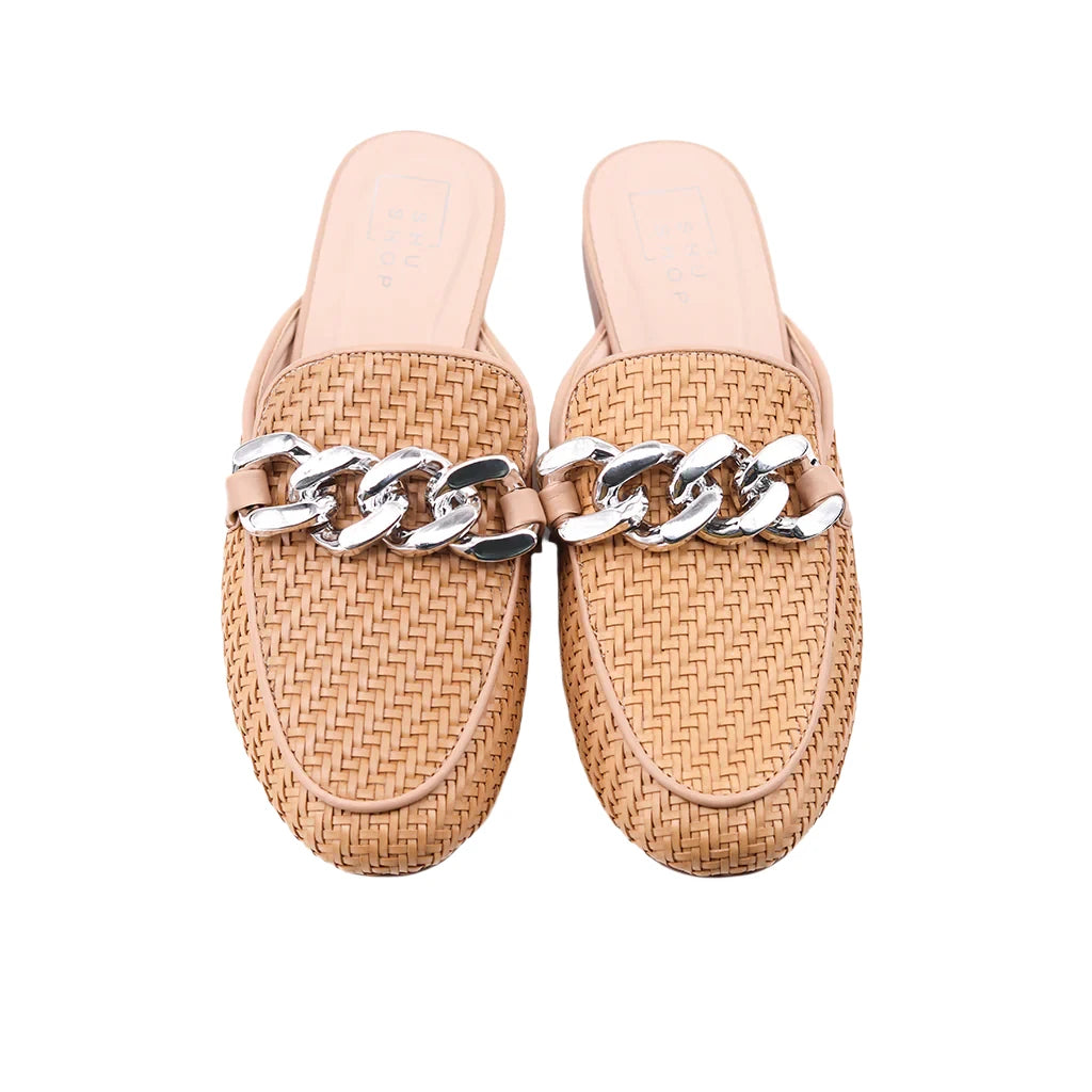 Elevate your style with the ALEXIS hybrid loafer-mule, now in a sophisticated nude hue. Crafted from intricately woven faux leather and embellished with a striking silver chain, this versatile piece effortlessly enhances any outfit. Perfect for work meetings or weekend brunch, ALEXIS pairs beautifully with everything from tailored trousers to casual denim, making it the ultimate essential for seamless day-to-night transitions