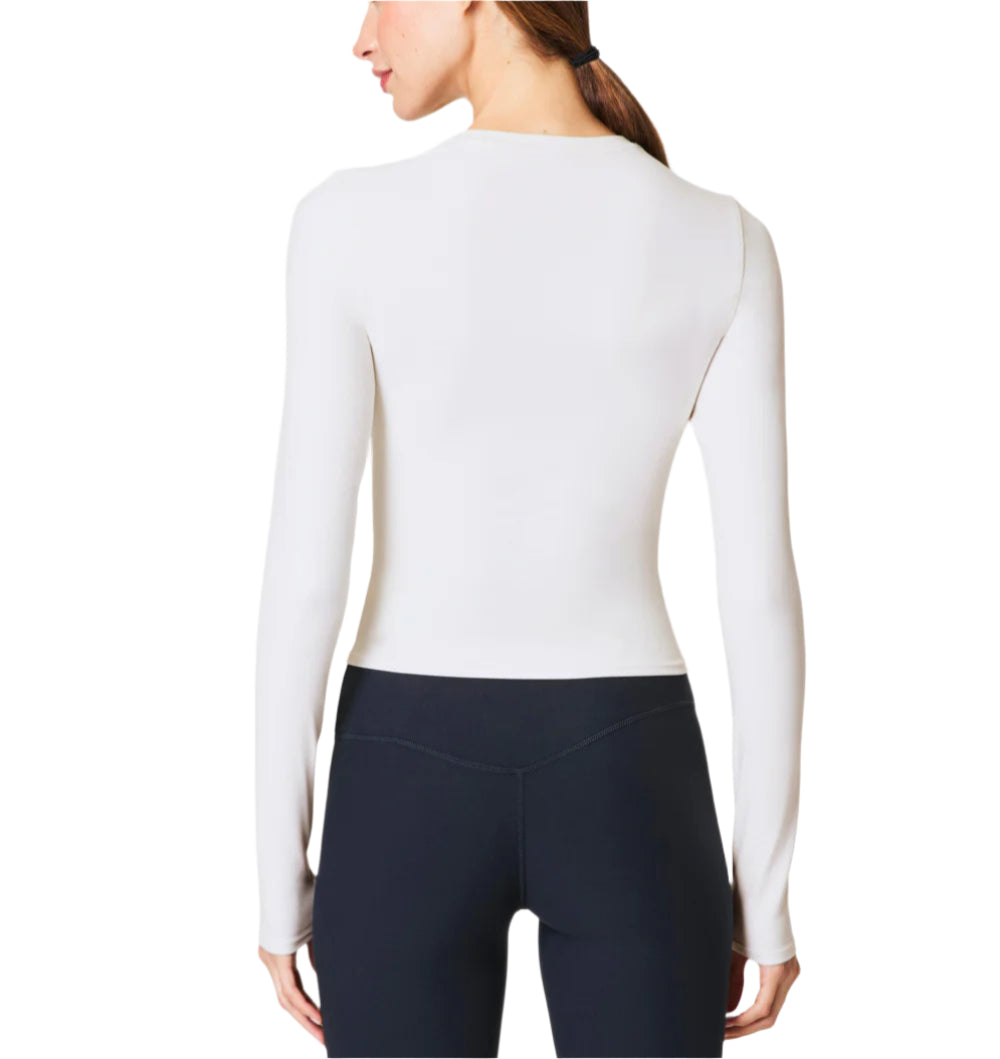 Our SPANXsmooth™ OnForm Long Sleeve Top is made from buttery-soft, lightweight performance fabric with gentle smoothing built in. Breathable, sweat-wicking, and crafted with 4-way stretch, this long sleeve shirt features convenient thumbholes for a secure fit (and added warmth). This versatile activewear style moves with you, and is perfect for before, during, and after your low-intensity workouts like pilates or yoga.