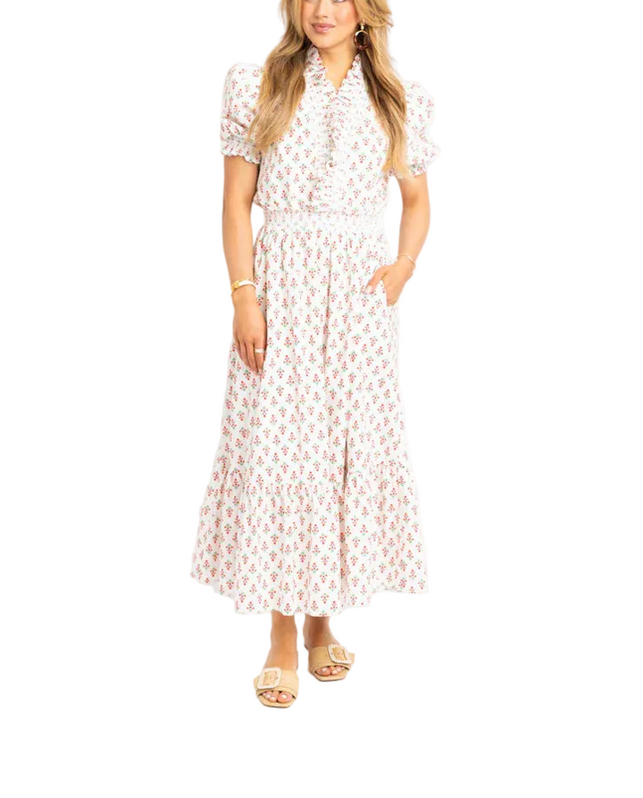 Effortless elegance meets comfort in this digital floral ruffle smock maxi dress. The soft ivory base features a vibrant all-over floral print that brings movement and personality to your wardrobe. Delicate ruffles frame the neckline and sleeves, while the relaxed smock silhouette provides a flattering, breathable fit perfect for warm weather. The flowing maxi length offers timeless sophistication for casual outings, garden parties, or weekend getaways.