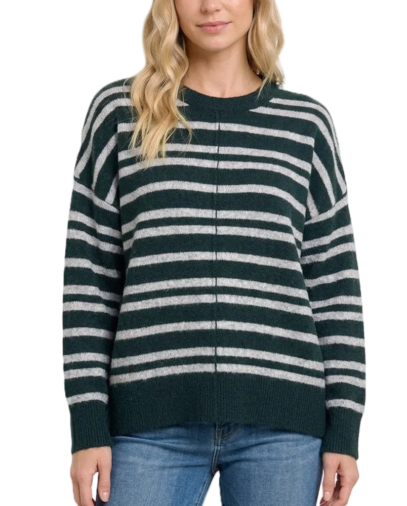 A woman wearing a dark green and light gray horizontally striped knit sweater with a front zipper, paired with blue jeans, against a solid light beige background.