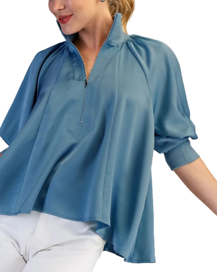 The high neck collar and unique zipper detail add a modern touch, while the loose, oversized fit ensures comfort and style. The puff sleeves create a chic, feminine silhouette. Perfect for both casual and dressy occasions. The smooth satin fabric drapes beautifully, offering a luxurious feel.
