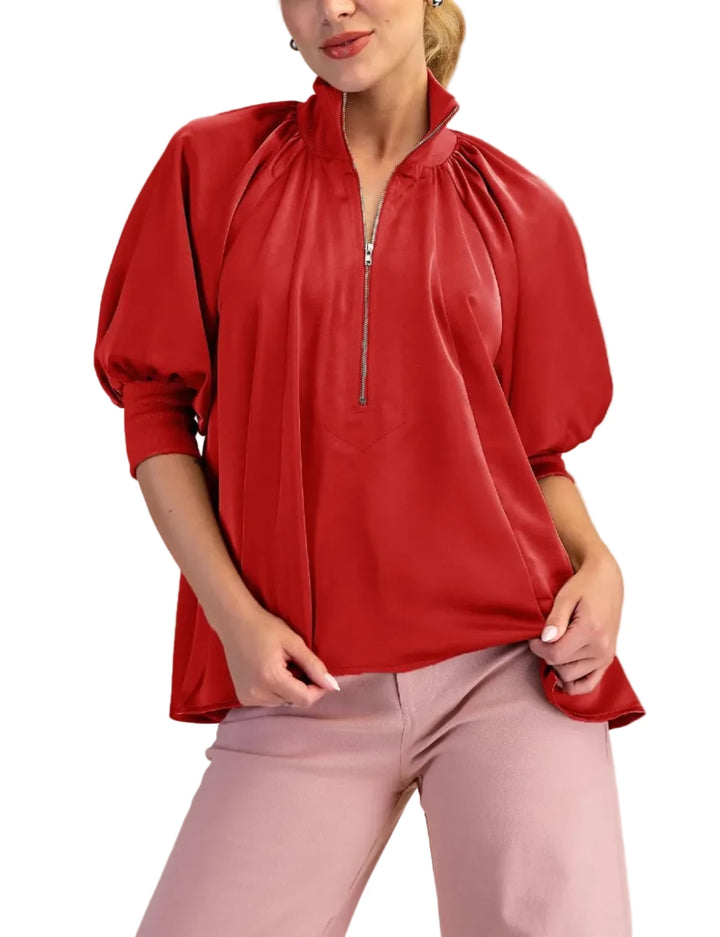 The high neck collar and unique zipper detail add a modern touch, while the loose, oversized fit ensures comfort and style. The puff sleeves create a chic, feminine silhouette. Perfect for both casual and dressy occasions. The smooth satin fabric drapes beautifully, offering a luxurious feel.
