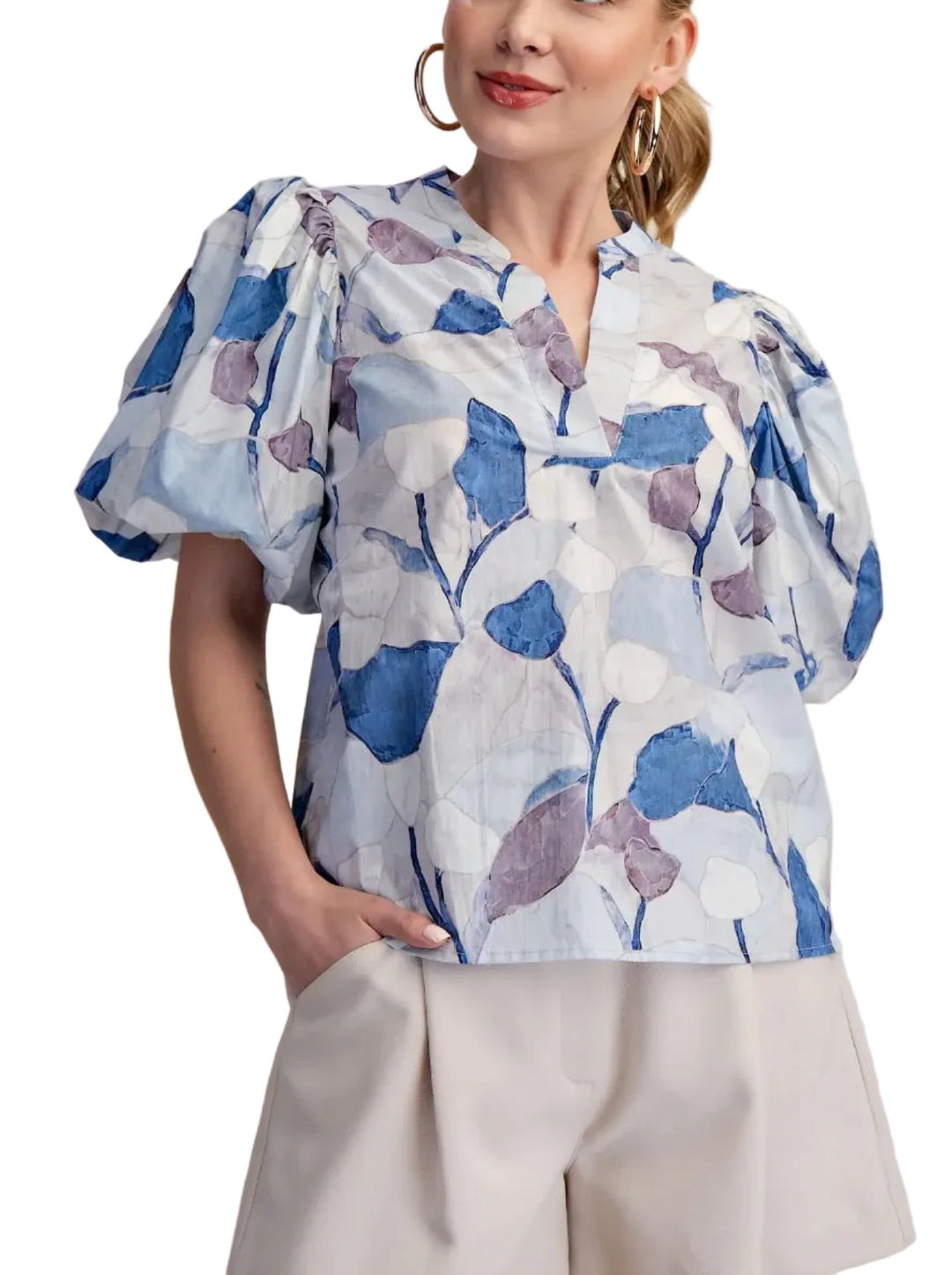 This exquisite puff sleeve blouse is a true embodiment of contemporary elegance and effortless style. Crafted from a lightweight, breathable fabric, it features a captivating abstract floral print in a soothing palette colors evoking a sense of artistic flair. This blouse is a testament to the beauty of thoughtful design, combining comfort with high-fashion appeal. It&