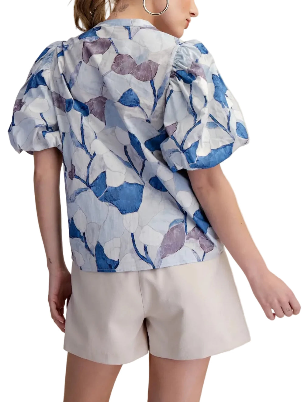 This exquisite puff sleeve blouse is a true embodiment of contemporary elegance and effortless style. Crafted from a lightweight, breathable fabric, it features a captivating abstract floral print in a soothing palette colors evoking a sense of artistic flair. This blouse is a testament to the beauty of thoughtful design, combining comfort with high-fashion appeal. It's a piece that promises to elevate any look, offering a blend of comfort, style, and a touch of whimsical charm.