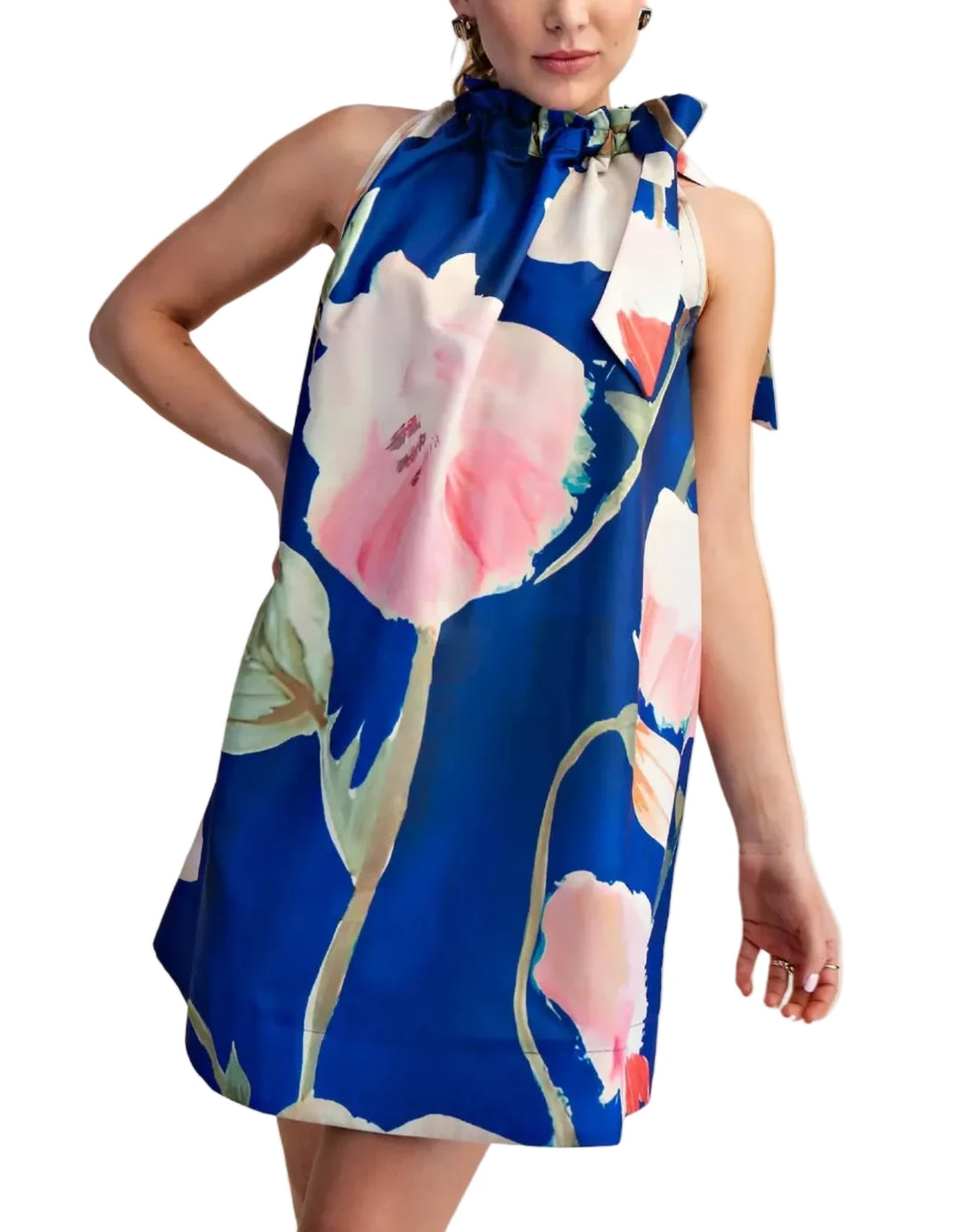 Woman wearing a blue floral dress against a beige background