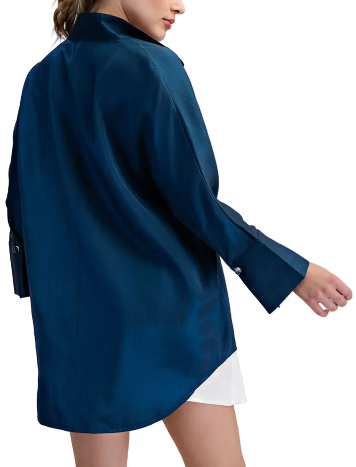 Elevate your wardrobe with this stunning stand collar long shirt. Crafted from a luxurious, lightweight fabric, it offers a sophisticated drape and a subtle sheen that catches the light beautifully. The design features a unique, high collar that can be worn up or folded down for versatile styling. Clear buttons on the front collar and the sleeves accentuate the placket, adding a touch of refined detail. The long sleeves are finished with wide cuffs, featuring a clear button closure for a polished look. This