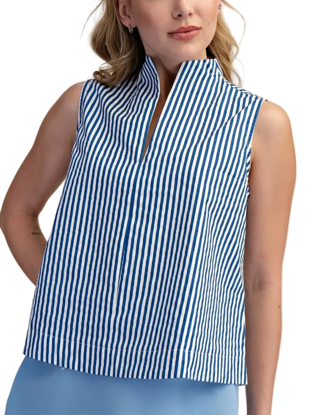 Woman wearing a blue and white striped sleeveless top against a beige background
