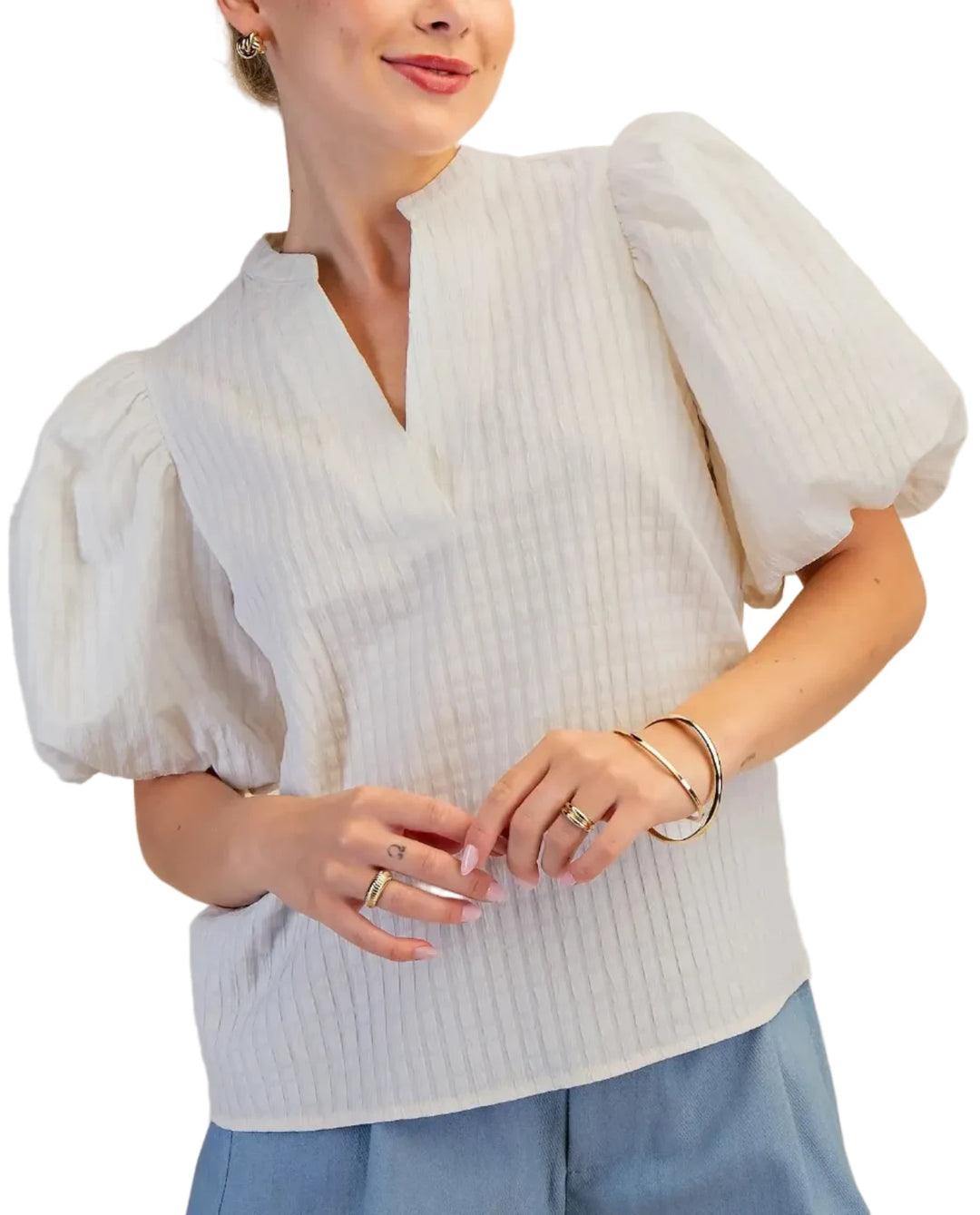 Elevate your wardrobe with this stunning puff sleeve top, designed to make a statement. Featuring dramatic puff sleeves and a unique waffle textured fabric, this blouse offers a sophisticated yet modern silhouette. The flattering V-neckline with a subtle keyhole detail adds a touch of allure, while the short sleeves provide comfort and ease of movement. Crafted from a high-quality material, this top drapes beautifully and feels as good as it looks. Perfect for dressing up or down, it pairs effortlessly with
