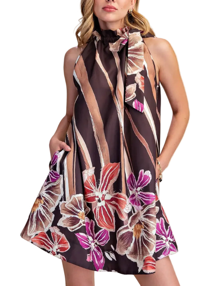 Embrace effortless style with this stunning floral print ruffle neck dress. The sleeveless design and tie-neck detail add a touch of sophistication, while the ruffled neckline brings a playful, feminine flair. Crafted from a lightweight, flowing fabric, this A-line mini dress is perfect for warm-weather occasions. Its vibrant floral pattern, set against a deep color background with abstract stripes, creates a chic and eye-catching look. Featuring convenient side pockets and a flattering silhouette, this ver