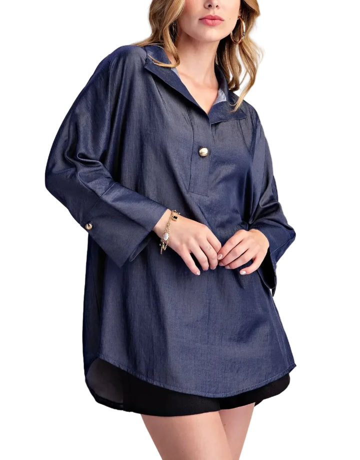 Elevate your casual style with this chic collared shirt blouse. Crafted from a lightweight, breathable fabric with a subtle sheen, this top offers a sophisticated take on a classic shirt. The relaxed fit drapes beautifully, providing comfort and effortless style. Featuring a unique collar with a single, elegant gold-tone button closure at the placket, it adds a touch of refined detail. The long sleeves are finished with neat cuffs, and the curved hemline creates a flattering silhouette. Perfect for pairing 
