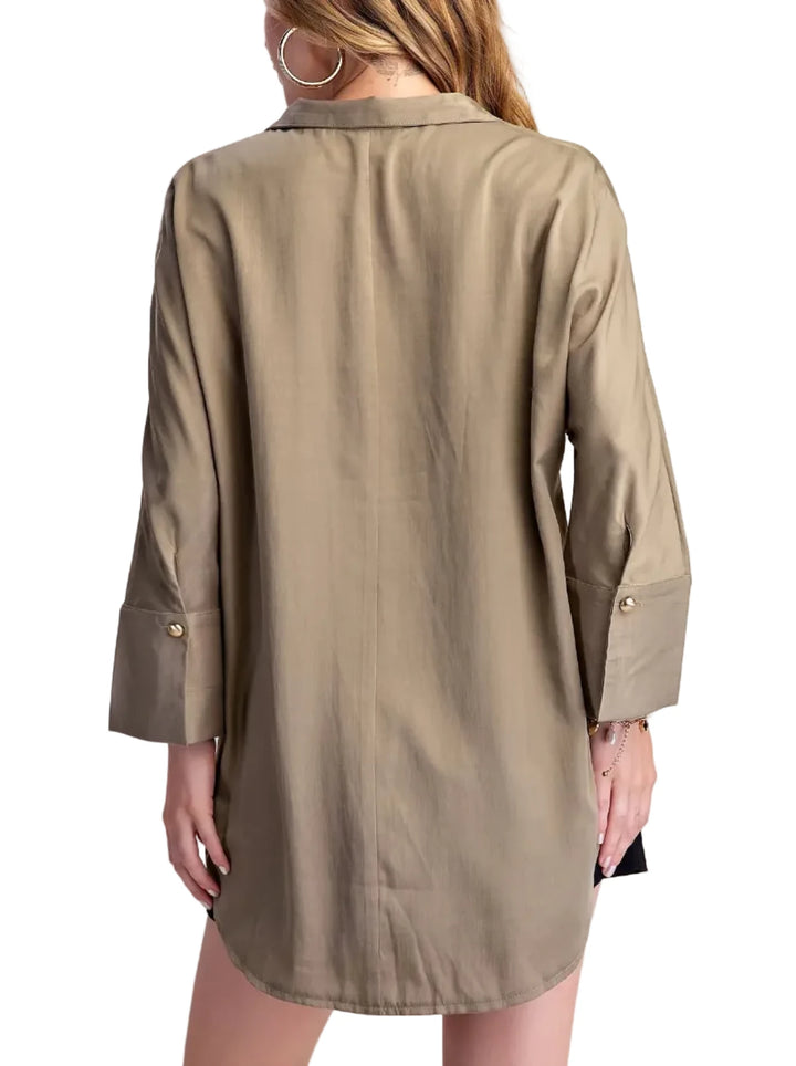 Elevate your casual style with this chic collared shirt blouse. Crafted from a lightweight, breathable fabric with a subtle sheen, this top offers a sophisticated take on a classic shirt. The relaxed fit drapes beautifully, providing comfort and effortless style. Featuring a unique collar with a single, elegant gold-tone button closure at the placket, it adds a touch of refined detail. The long sleeves are finished with neat cuffs, and the curved hemline creates a flattering silhouette. Perfect for pairing 