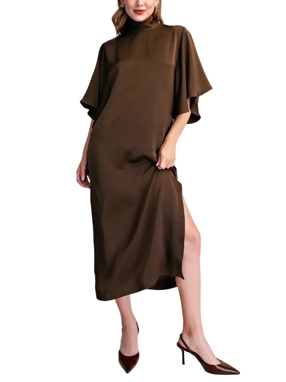 A woman modeling a dark brown high-neck midi dress with wide draped sleeves and a side slit, paired with dark brown pointed-toe heels, against a plain beige studio background.