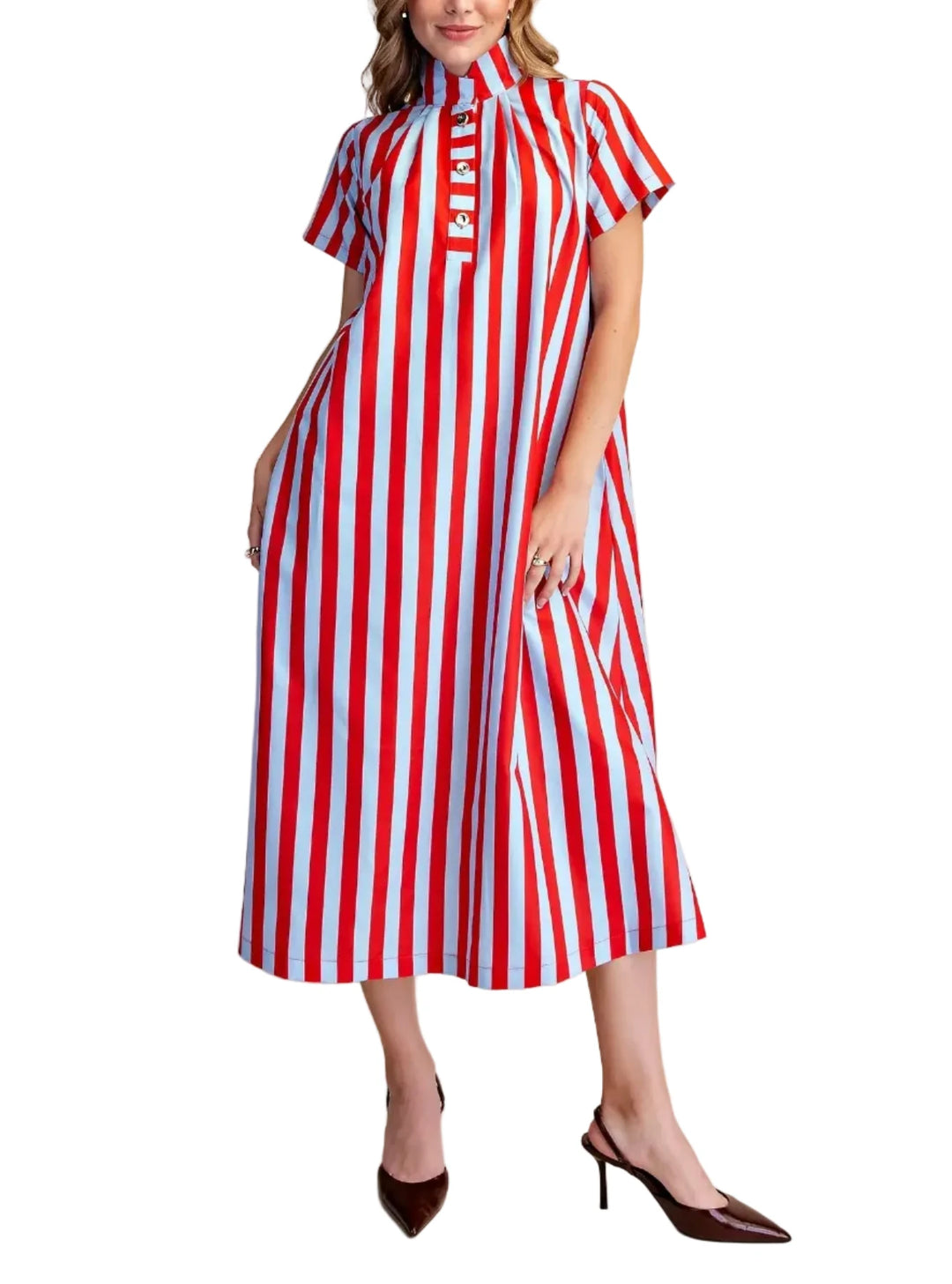 A woman modeling a midi-length dress with vertical red, white, and light blue stripes, featuring short puff sleeves, a mock neck, and a buttoned placket, paired with dark brown pointed-toe heels against a solid beige studio background.