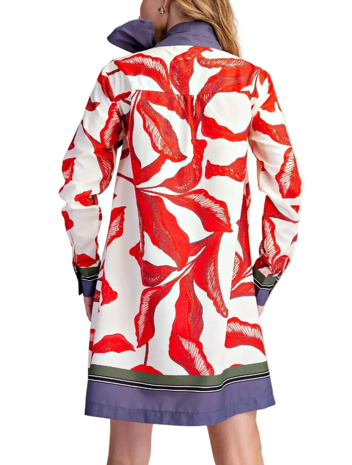 Make a vibrant statement with this eye-catching print mini dress. Featuring a striking leaf print in shades of holiday mood, this dress is designed to turn heads. The bold, oversized bow at the neckline adds a playful yet sophisticated touch, perfect for any cocktail or holiday / party occasion. Long sleeves and a flattering A-line silhouette ensure comfort and style, while the contrasting red and white striped trim at the hem and cuffs adds a modern flair. This dress is an ideal choice for those who love t
