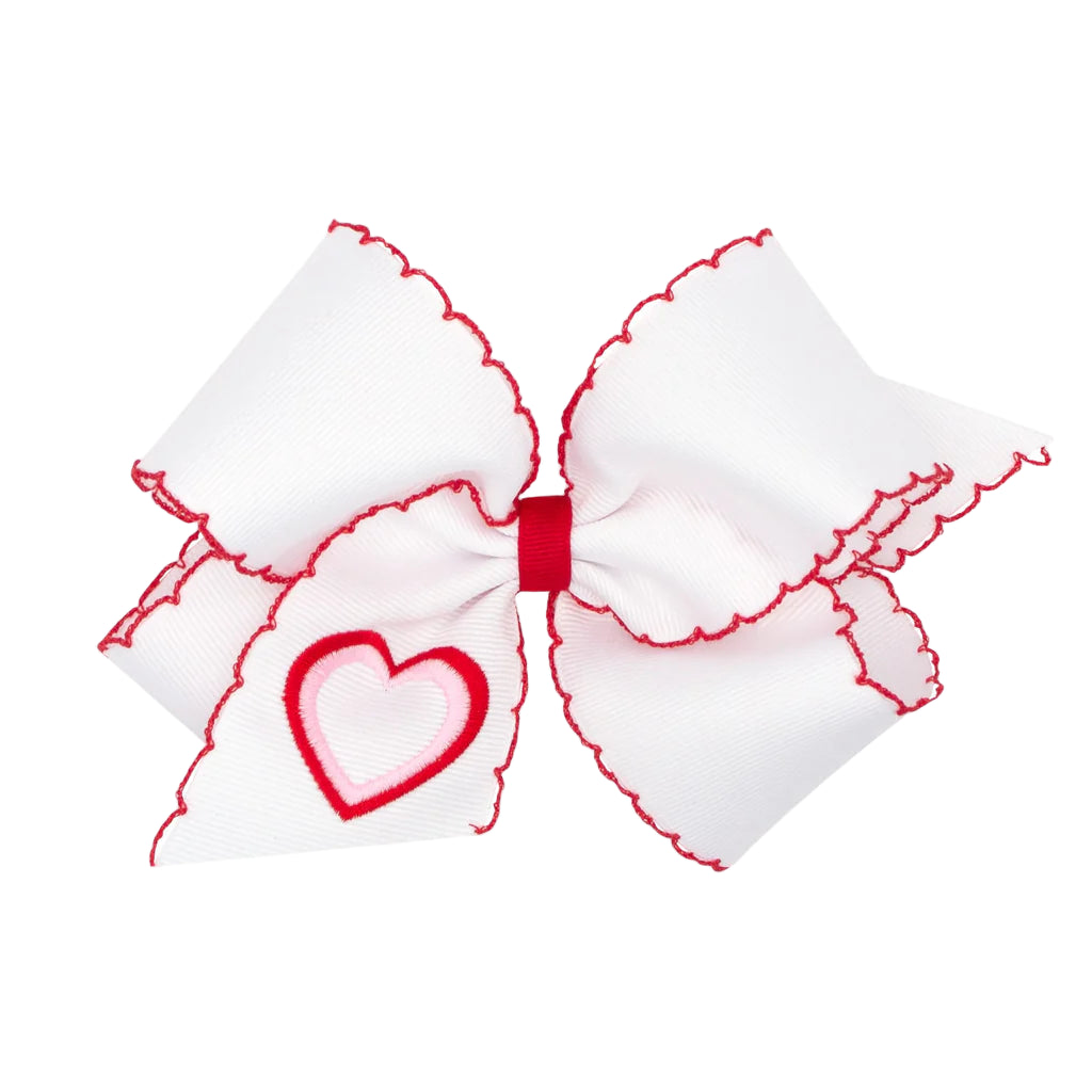 White bow with red accents and a heart design on a white background