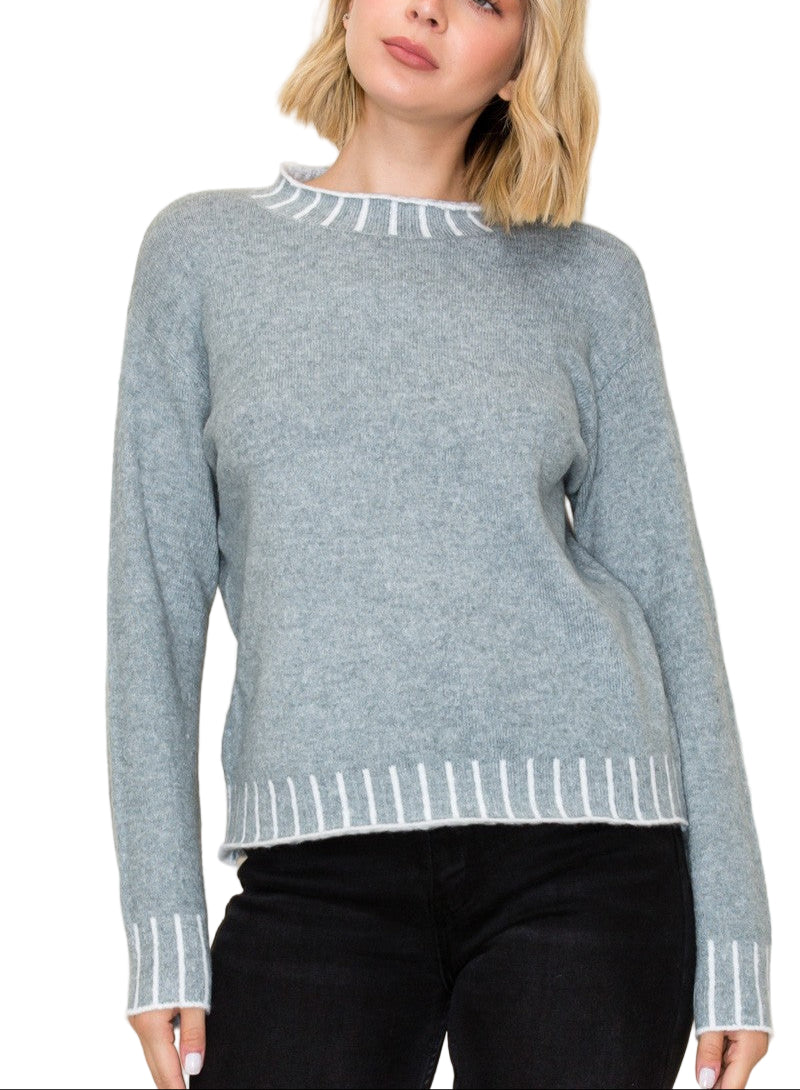 Stay cozy and stylish in the Kerr Mock Neck Sweater, featuring a charming color texture accent that adds a fun twist to your everyday look. Its playful mock neck design keeps you snug while letting your personality shine. Perfect for layering or wearing solo, this sweater brings warmth and a pop of character to chilly days.