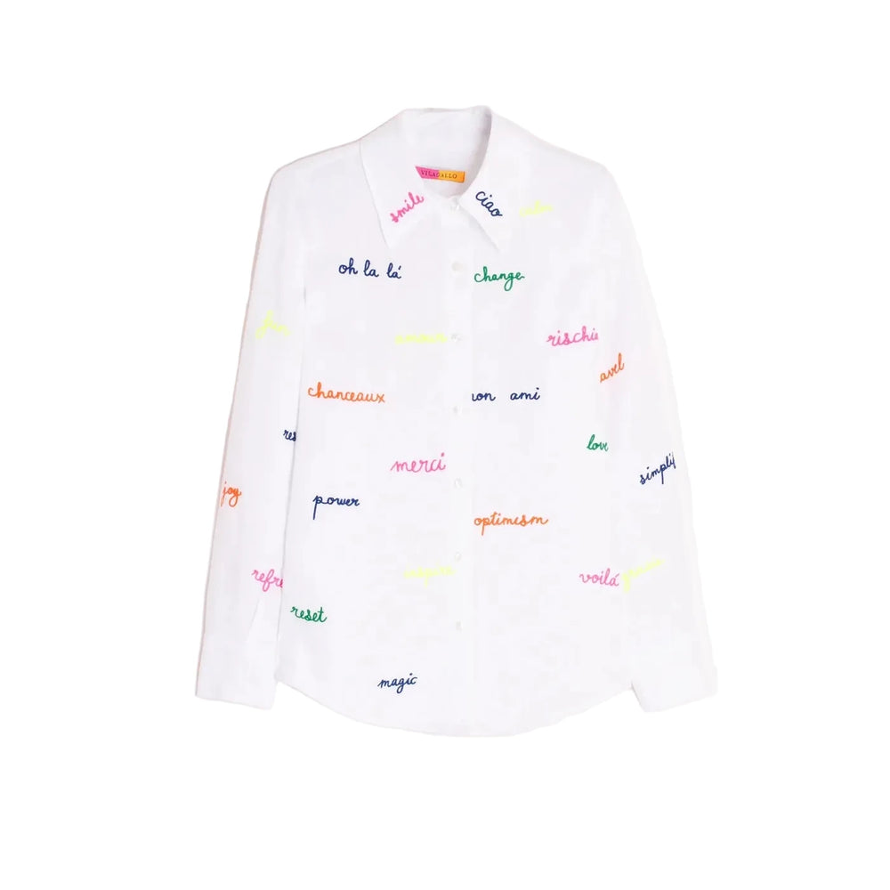 White shirt with embroidered words in fluorescent colors on the front and sleeves. Features a classic shirt collar, button-front closure, and long sleeves. Rounded hem. 