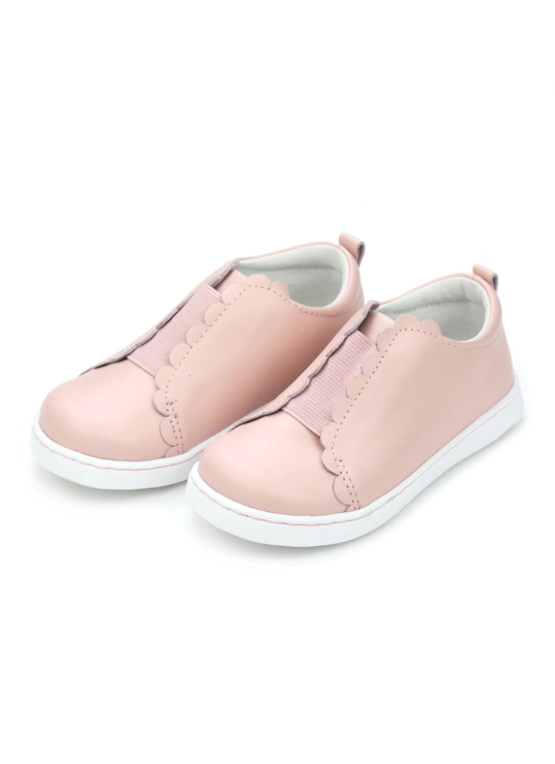 Scalloped and sweet, sister to the Caroline, the the Phoebe is the first slip on sneaker in our collection. We love the matching elastic for a semi-sporty look; Phoebe comes with a leather sock bed with memory foam for greater breathability, durability, and comfort as leather conforms to the shape of the foot.
