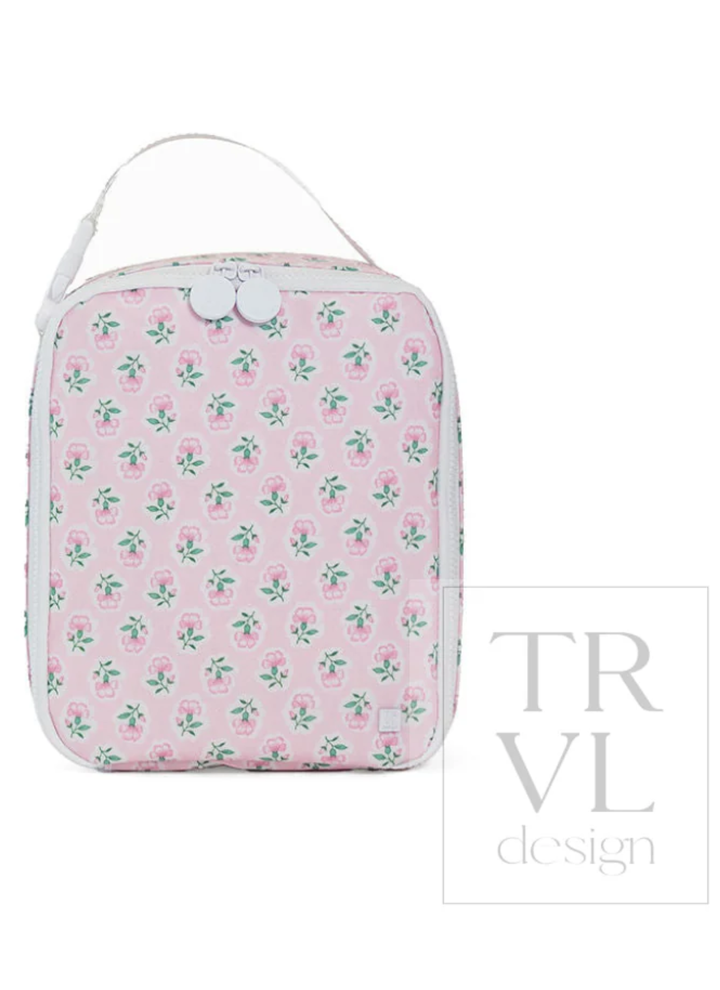 Pink floral-patterned toiletry bag with white strap on a white background, featuring the TRVL design logo.
