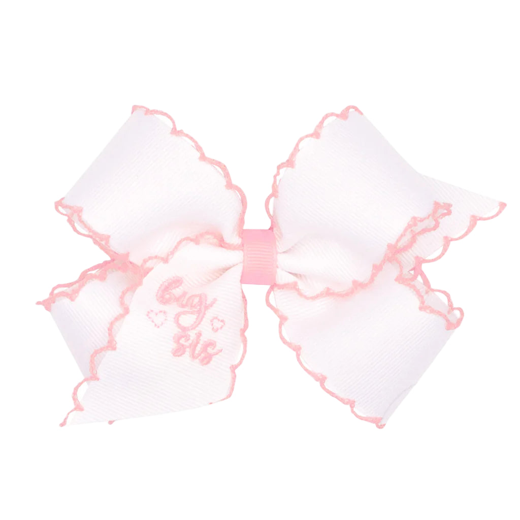 White bow with pink accents and &