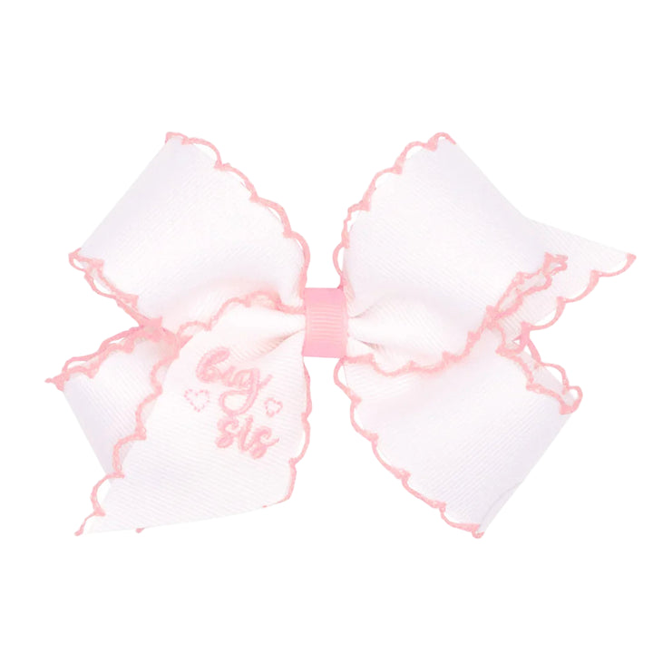 White bow with pink accents and &