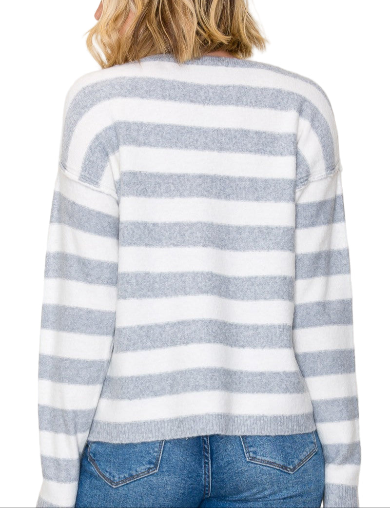 Wrap yourself in cozy charm with the Shannon Striped Crew Neck Sweater. Its playful stripes and classic crew neck make it the perfect pick for brightening up chilly days. Soft and comfortable, this sweater pairs effortlessly with your favorite jeans or skirts for a fun, laid-back look. Get ready to turn heads and stay snug all season long!