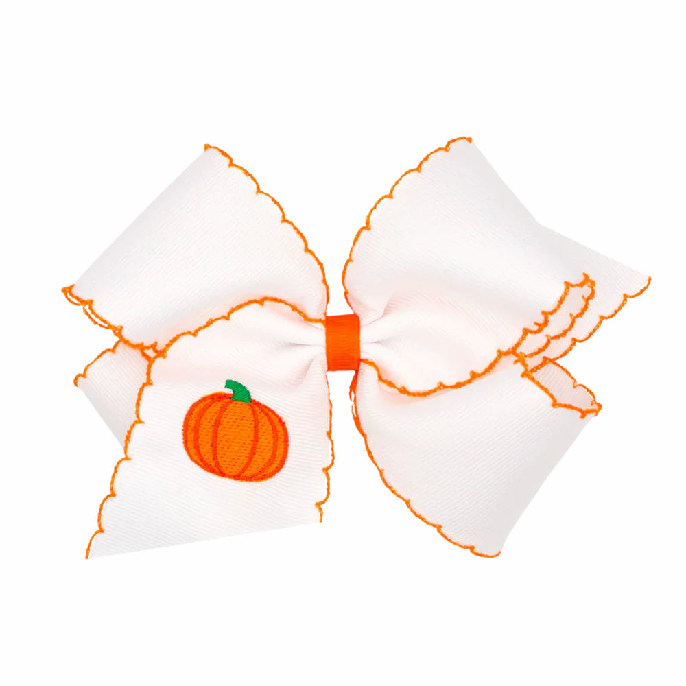 White bow with orange pumpkin design on a white background