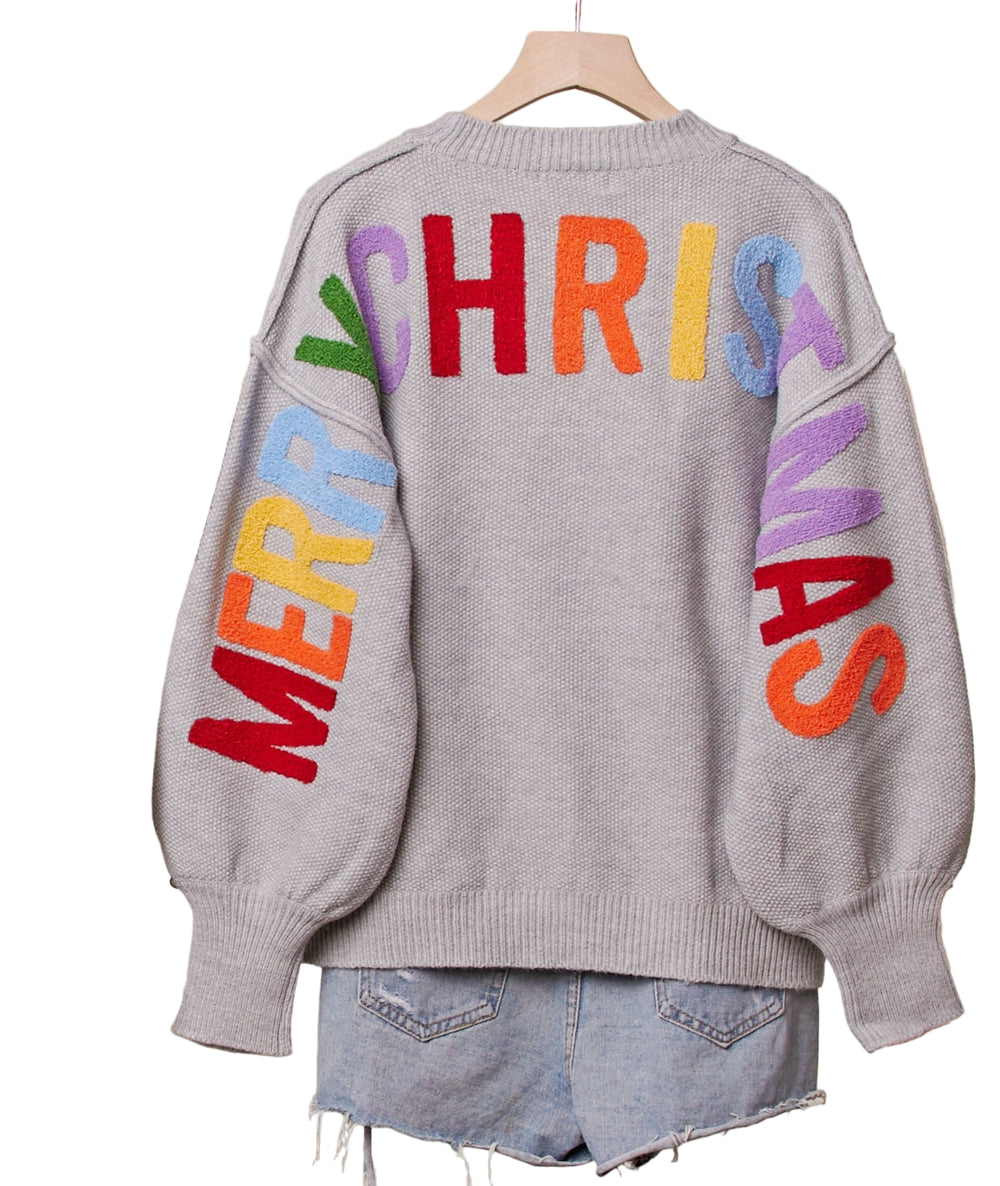 Celebrate the season in cozy style with this Oversize Christmas Sweater featuring festive lettering on both front and back. Its roomy fit keeps you comfy for holiday parties, while the bold text spreads cheer wherever you go. Perfect for sipping cocoa or rocking around the Christmas tree, this sweater makes festive fun effortless and playful.