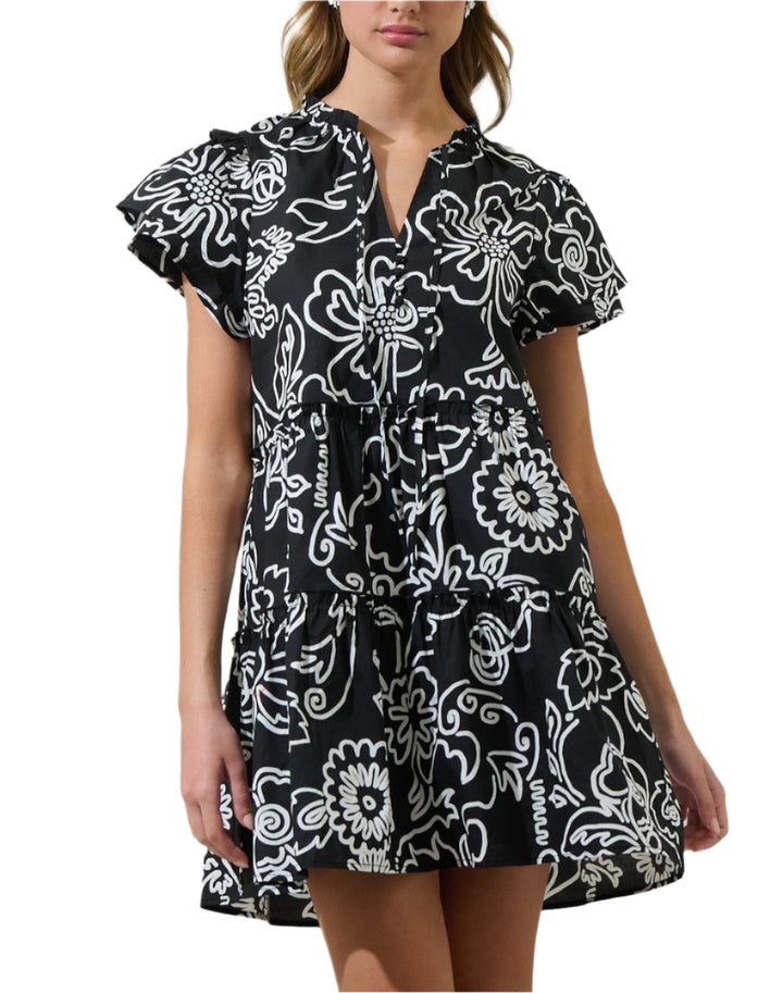 Get ready for an undeniably cute day in this dress. This flirty woven mini dress features a split neckline and short sleeves with ruffle layers. Fitted waist is accented with decorative tiers of ruffle trim that accent the flaring mini skirt below. Pair it with ankle boots and a crossbody bag for the perfect finish.