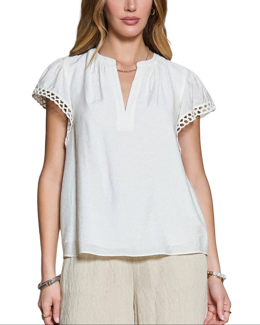 Effortless elegance meets comfortable style with the Callie Crochet Detail Top. This short sleeve v-neck features delicate crochet detailing that adds texture and visual interest to an otherwise timeless silhouette. Perfect for layering or wearing solo, the relaxed fit and breathable fabric make it ideal for warm weather days. Pair with your favorite jeans or linen pants for an understated, polished look.