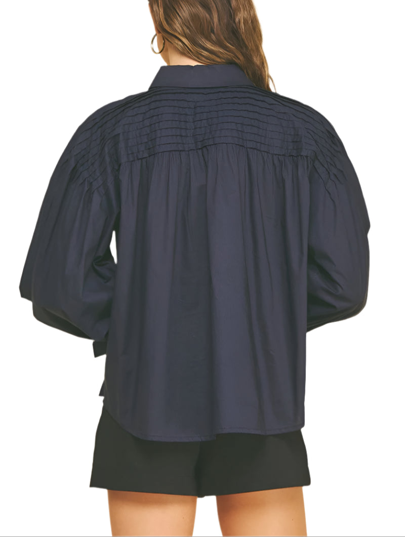 Add a touch of charm to your wardrobe with the Marney Detail Blouse. Featuring a playful tucked design and a sweet tie detail at the cuffs, this top brings effortless style and a flirty finish to any outfit. Perfect for days when you want to feel both comfortable and cute!