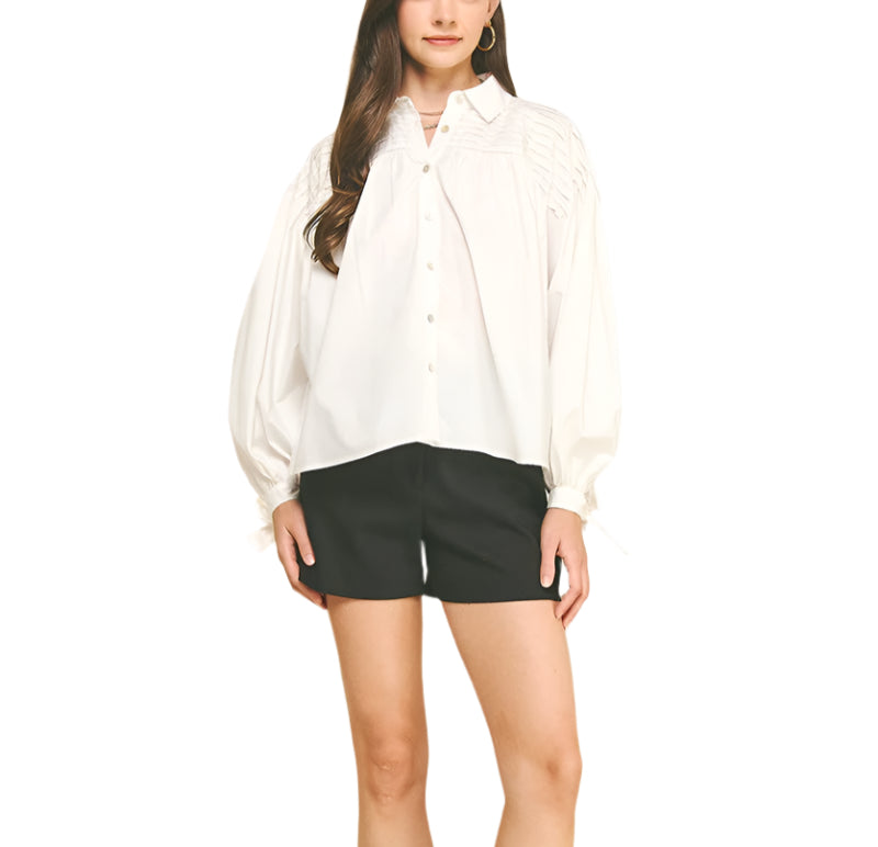 Add a touch of charm to your wardrobe with the Marney Detail Blouse. Featuring a playful tucked design and a sweet tie detail at the cuffs, this top brings effortless style and a flirty finish to any outfit. Perfect for days when you want to feel both comfortable and cute!