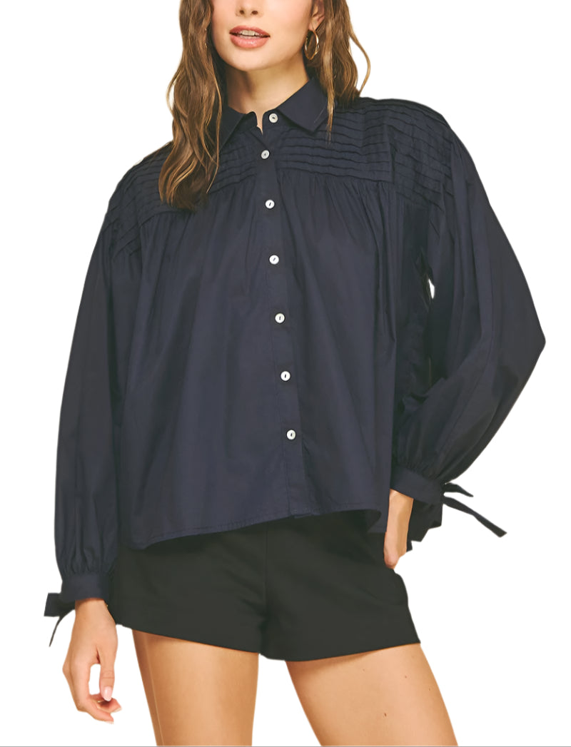 Add a touch of charm to your wardrobe with the Marney Detail Blouse. Featuring a playful tucked design and a sweet tie detail at the cuffs, this top brings effortless style and a flirty finish to any outfit. Perfect for days when you want to feel both comfortable and cute!