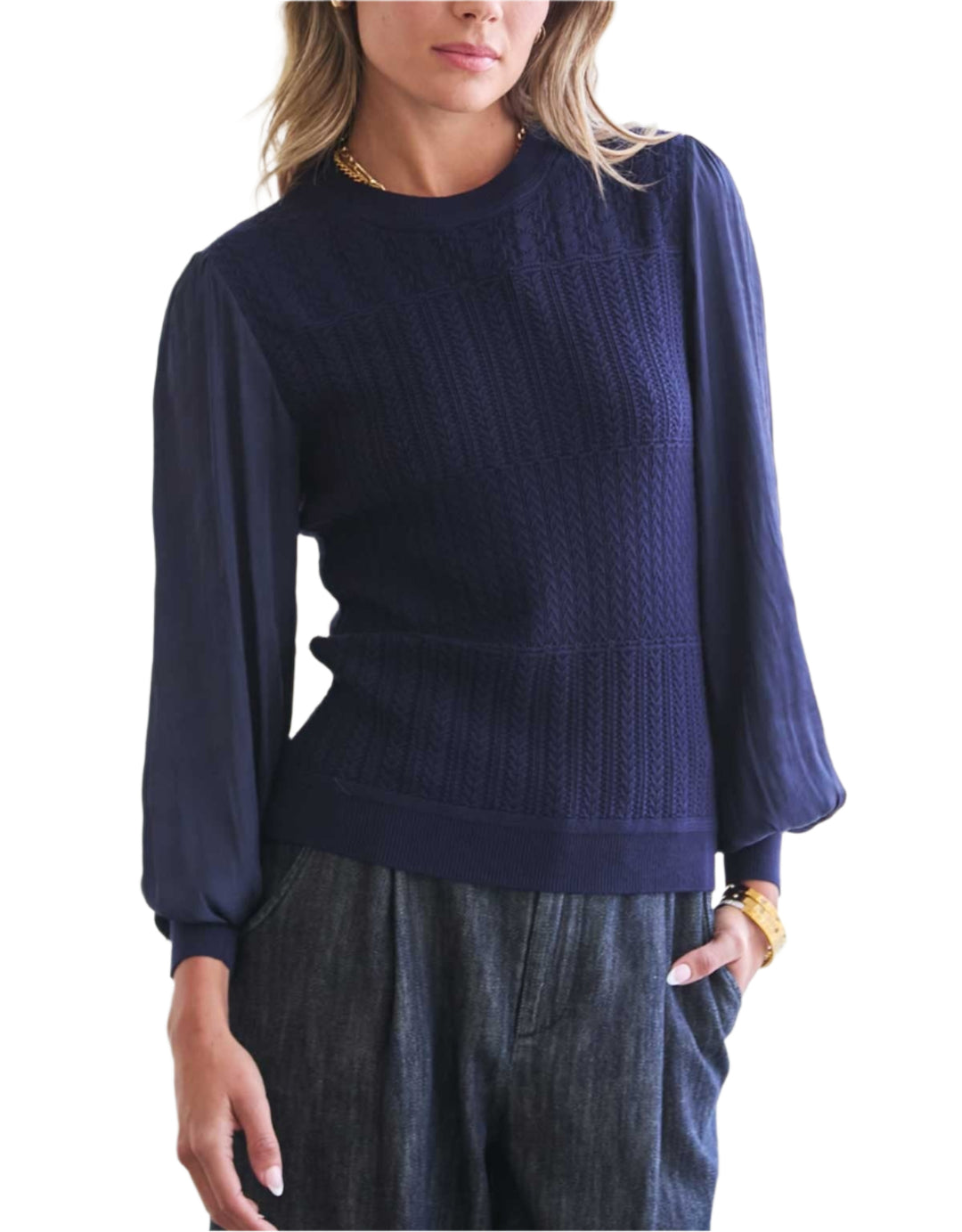 Woman wearing a navy blue sweater against a white background
