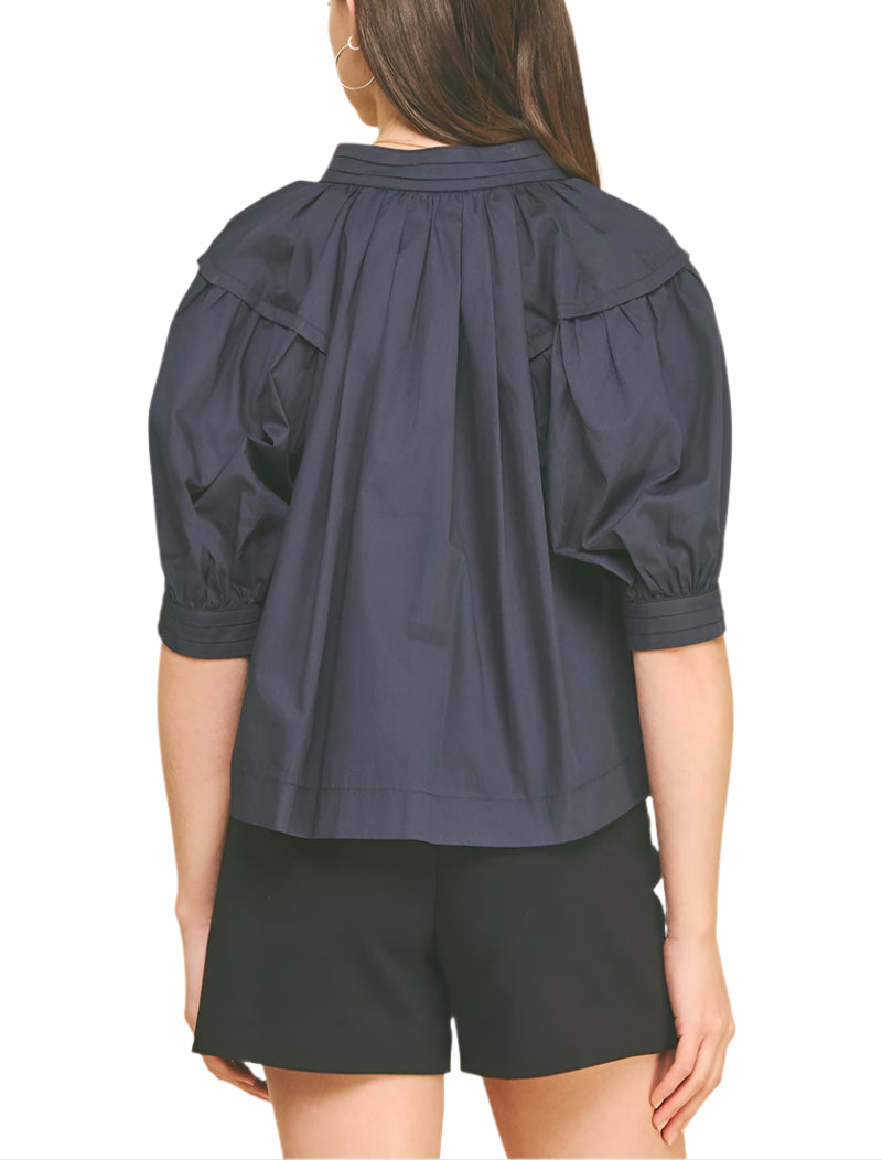The Effie Blouse brings a playful twist to your wardrobe with its charming balloon sleeves and flattering V-neckline.