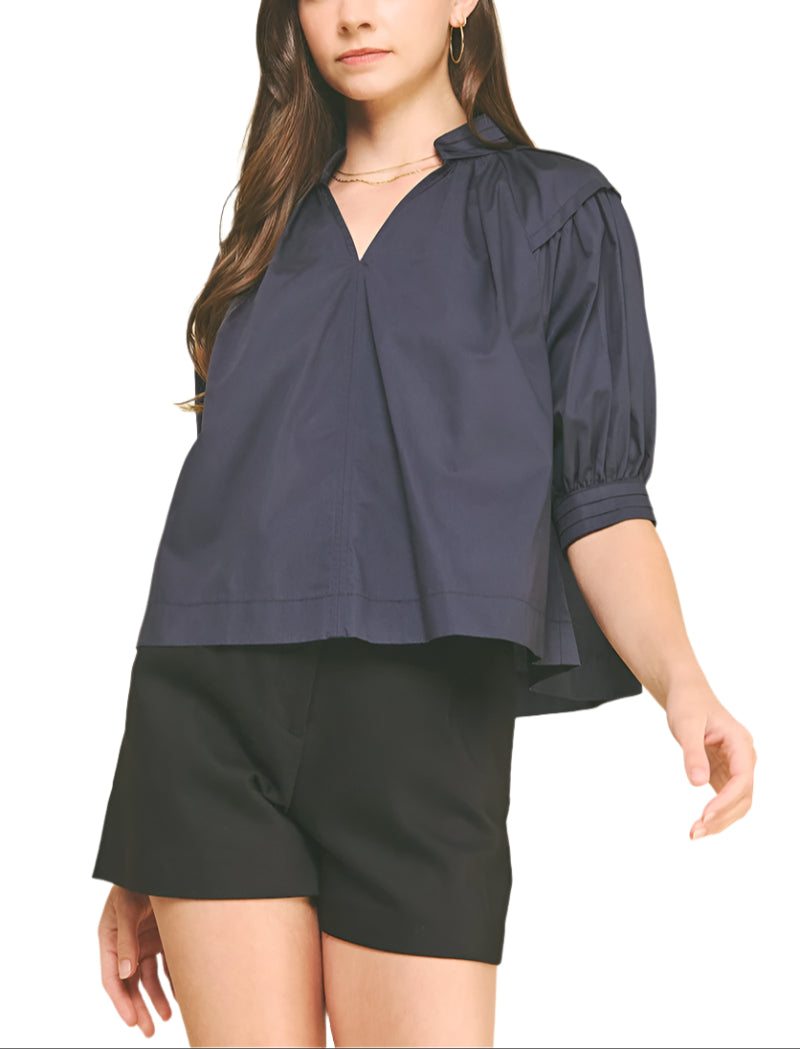 The Effie Blouse brings a playful twist to your wardrobe with its charming balloon sleeves and flattering V-neckline.
