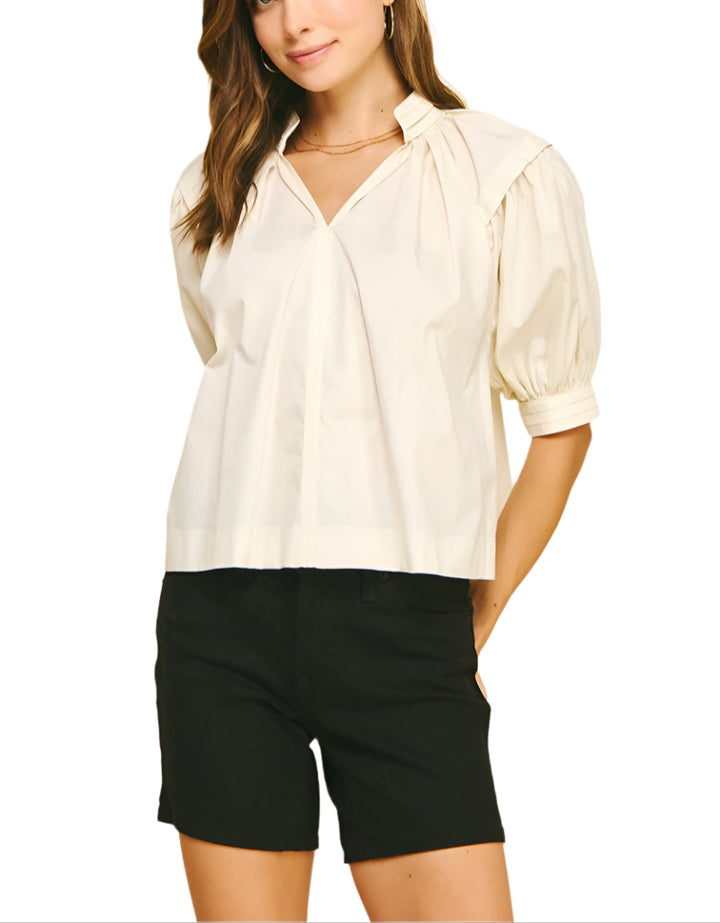 The Effie Blouse brings a playful twist to your wardrobe with its charming balloon sleeves and flattering V-neckline.