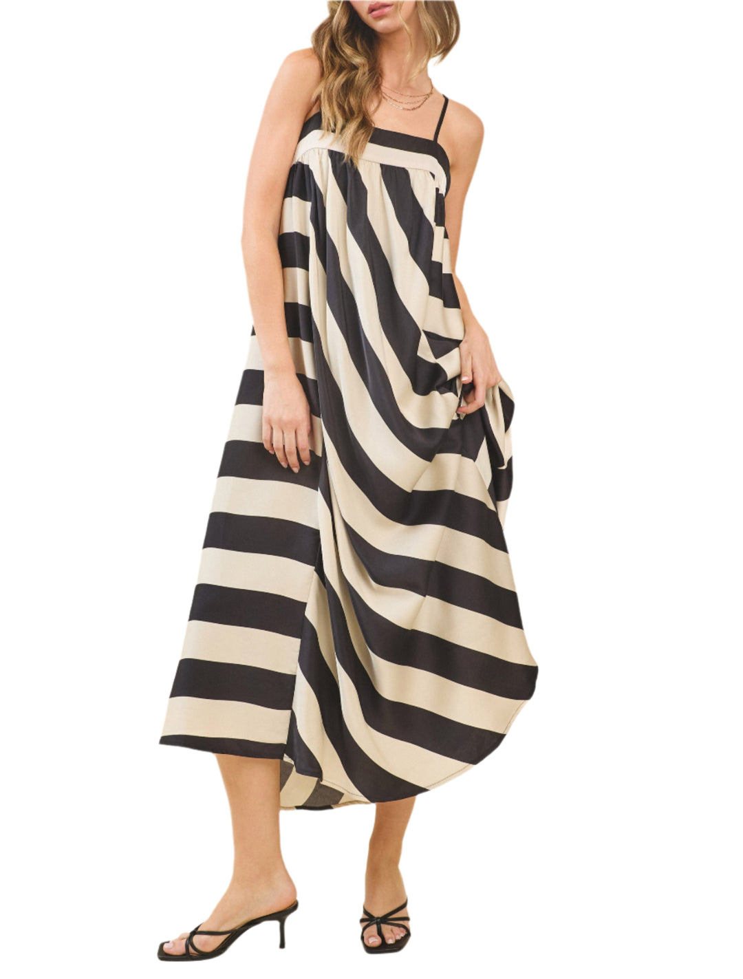Flowy maxi dress featuring bold diagonal stripes, adjustable straps, and a smocked back. Finished with contrast trim at the neckline. Back Hidden Zipper Closures.
