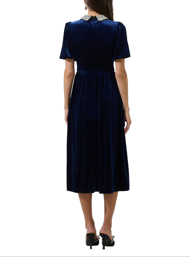 This velvet midi dress features a rhinestone collar, short balloon sleeves and an invisible back zipper for a seamless fit.