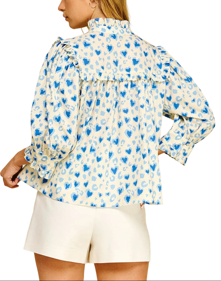 Spread the love with this charming Valerie Heart Pattern Top! Featuring an adorable heart print throughout, this playful piece combines romantic style with practical comfort. The button-down front makes dressing a breeze, while voluminous balloon sleeves add a whimsical touch. Delicate ruffle detailing frames the neckline and cuffs for extra feminine flair. Perfect for date nights, casual outings, or whenever you want to wear your heart on your sleeve—literally!