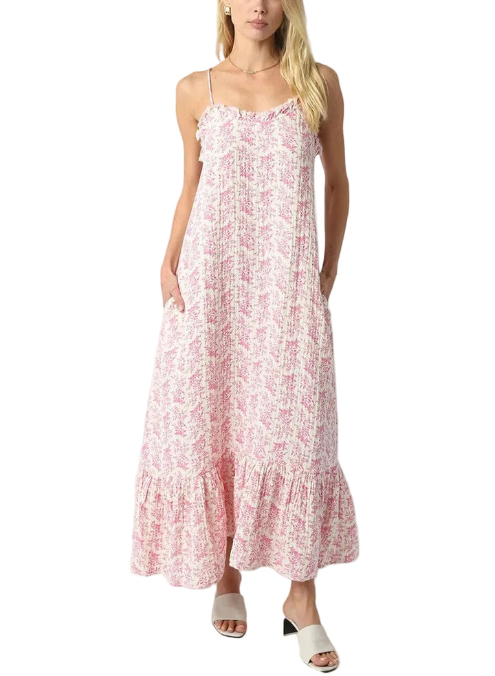 Twirl into spring with this adorable two-piece set featuring a cropped top with charming puff sleeves and an all-over pink floral print. The coordinating midi skirt completes the look with the same delicate botanical design, creating a perfectly put-together outfit that&