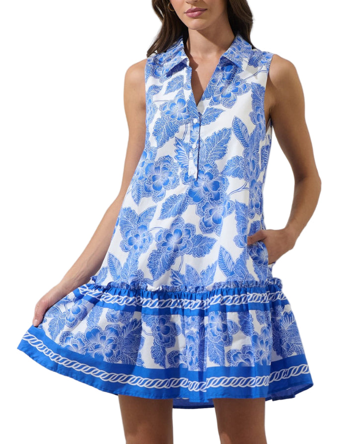 Woman wearing a blue and white floral dress on a white background