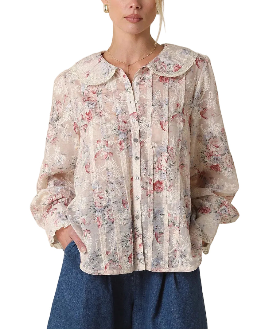 Introducing the Carla Pintuck Floral Blouse—where timeless elegance meets modern flair. This charming piece features delicate pintuck detailing that adds dimension and sophistication, while the vibrant cream, red, and green floral print brings personality to any outfit. Perfect for elevating your everyday style or dressing up for special occasions, this blouse pairs effortlessly with jeans, skirts, or tailored trousers. 