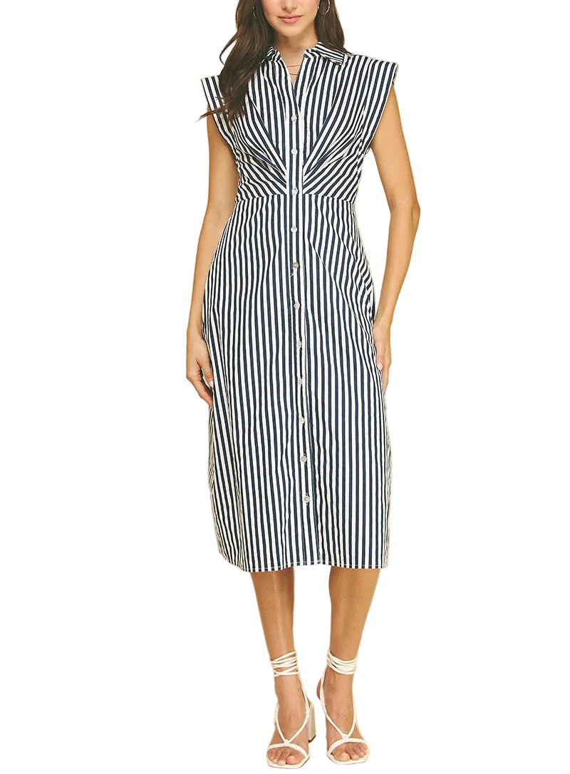 Woman wearing a black and white striped dress on a beige background