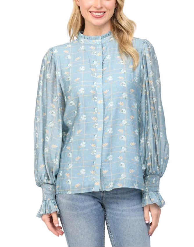 Twirl into spring with our Candy Dusty Blue Blouse, where vintage charm meets modern flair. This delightful piece features a romantic floral print that dances across soft, dusty blue fabric, while playful ruffles frame an elegant stand collar for that perfect touch of whimsy. The structured neckline keeps things polished, while the ruffled details add movement and personality to your everyday look. Perfect for brunch dates, garden parties, or whenever you want to add a little extra joy to your wardrobe.