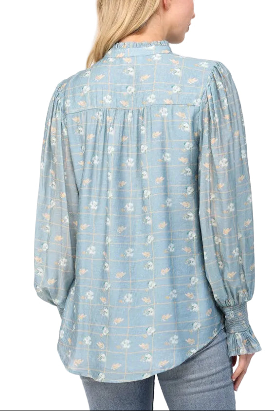 Twirl into spring with our Candy Dusty Blue Blouse, where vintage charm meets modern flair. This delightful piece features a romantic floral print that dances across soft, dusty blue fabric, while playful ruffles frame an elegant stand collar for that perfect touch of whimsy. The structured neckline keeps things polished, while the ruffled details add movement and personality to your everyday look. Perfect for brunch dates, garden parties, or whenever you want to add a little extra joy to your wardrobe.