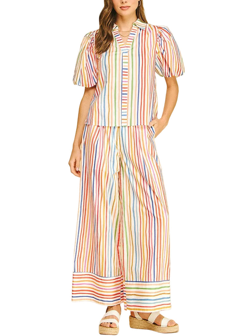 Brighten your wardrobe with the Rainey Rainbow Stripe Pant Set. This cheerful two-piece features vibrant horizontal stripes in classic rainbow hues, perfect for making a bold statement. The coordinated top and pants offer comfortable everyday wear with eye-catching style. Ideal for casual outings, playdates, or anyone who loves color and confidence.