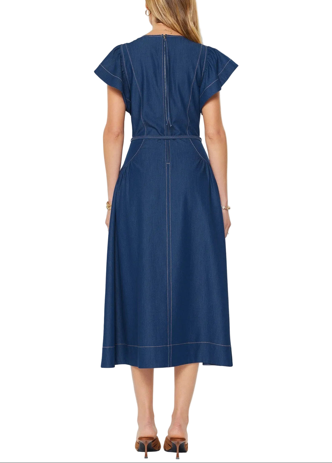 Effortless elegance meets everyday comfort in this Amy Denim A-Line Midi Dress. The flattering V-neckline and flutter sleeves create a romantic silhouette, while the structured A-line skirt skims gracefully over the body. A coordinating waist tie cinches at the narrowest point, defining your shape and adding a polished finishing touch. Perfect for casual outings or dressed up for special occasions, this versatile denim piece transitions seamlessly from season to season.